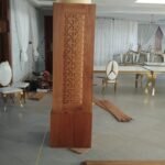 Column clad in hardwood with a laser-cut fretwork panel