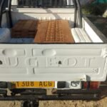 Pickup loaded with finished timber components leaving for site