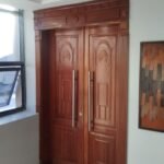 Hand-carved solid hardwood double doors with moulded frame and cornice