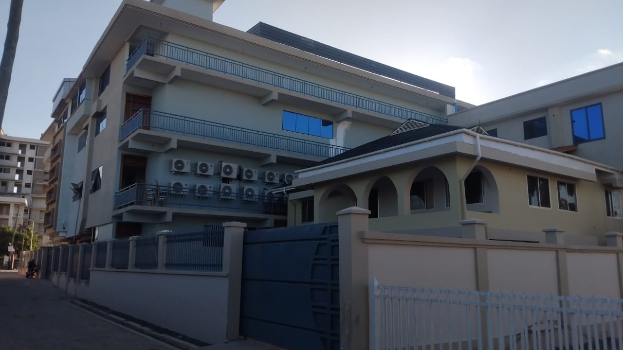 Completed multi-storey building in Dar es Salaam with external timber and finishing works by Simba Umeme
