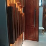 Slatted timber feature wall with concealed LED lighting in a Dar es Salaam interior