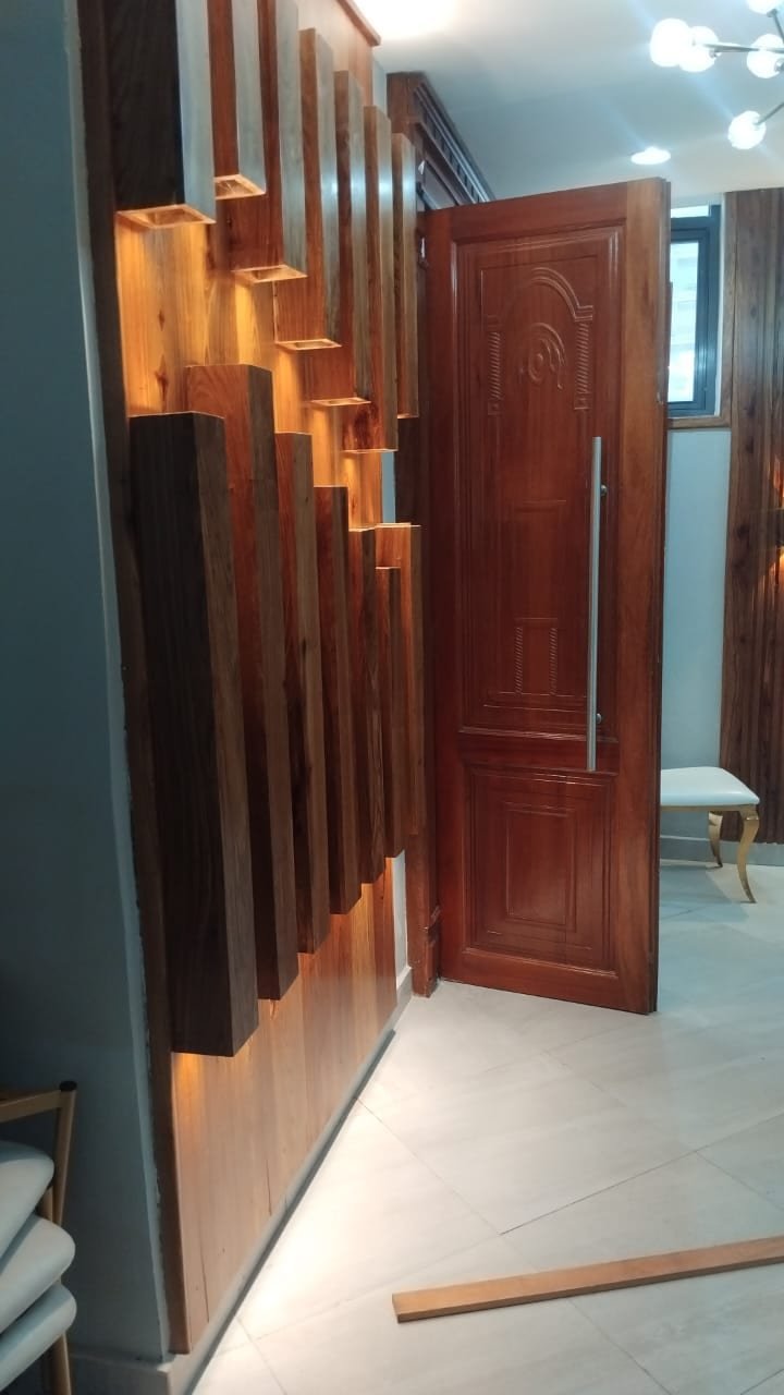 Slatted timber feature wall with concealed LED lighting in a Dar es Salaam interior