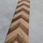 Chevron hardwood floor inlay set into a tiled banquet hall floor