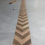 Chevron hardwood floor inlay running the length of a banquet hall