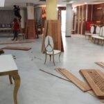 Decorative column casings and tables positioned during a venue fit-out