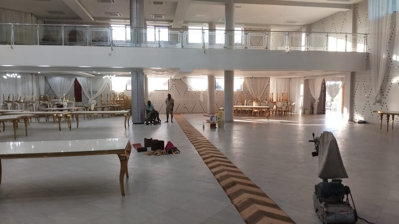 Banquet hall furnished with gold-frame chairs and white-top tables supplied by Simba Umeme