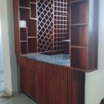 Built-in timber bar unit with wine rack and fluted counter front made by Simba Umeme