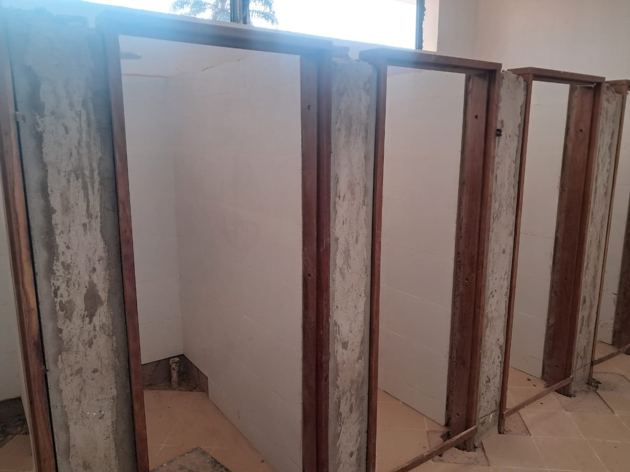 Timber-framed washroom partitions installed by Simba Umeme on an institutional project