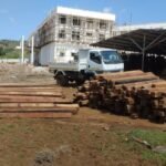 Hardwood beams stacked on site ready for cutting and installation