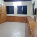 Fitted bedroom with hardwood louvre wardrobes, base units, mirrors and a run of counter